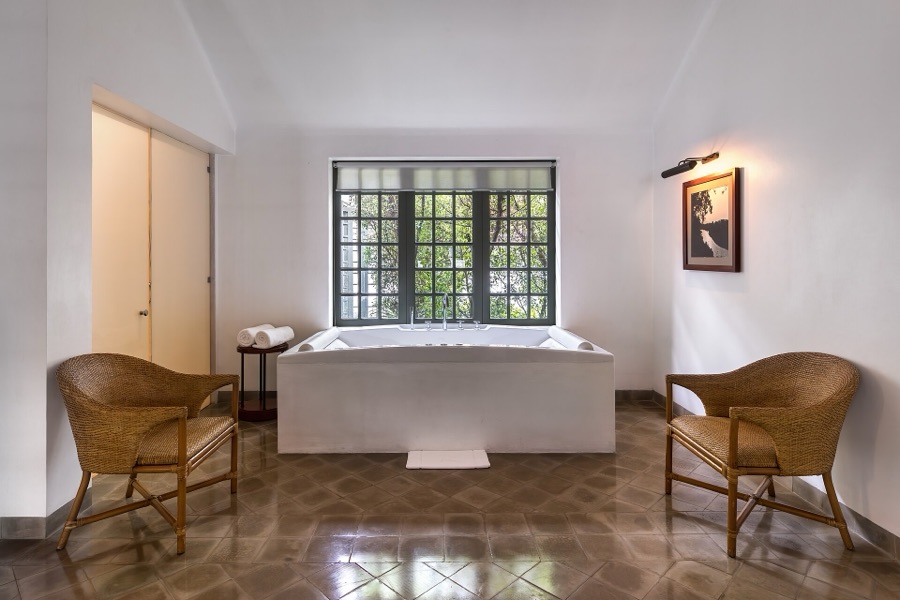 A serene spa bath and chairs in soft natural light